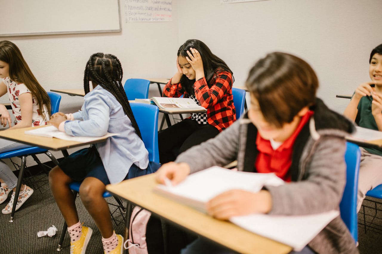Diverse group of students engaged in study session inside a classroom setting.